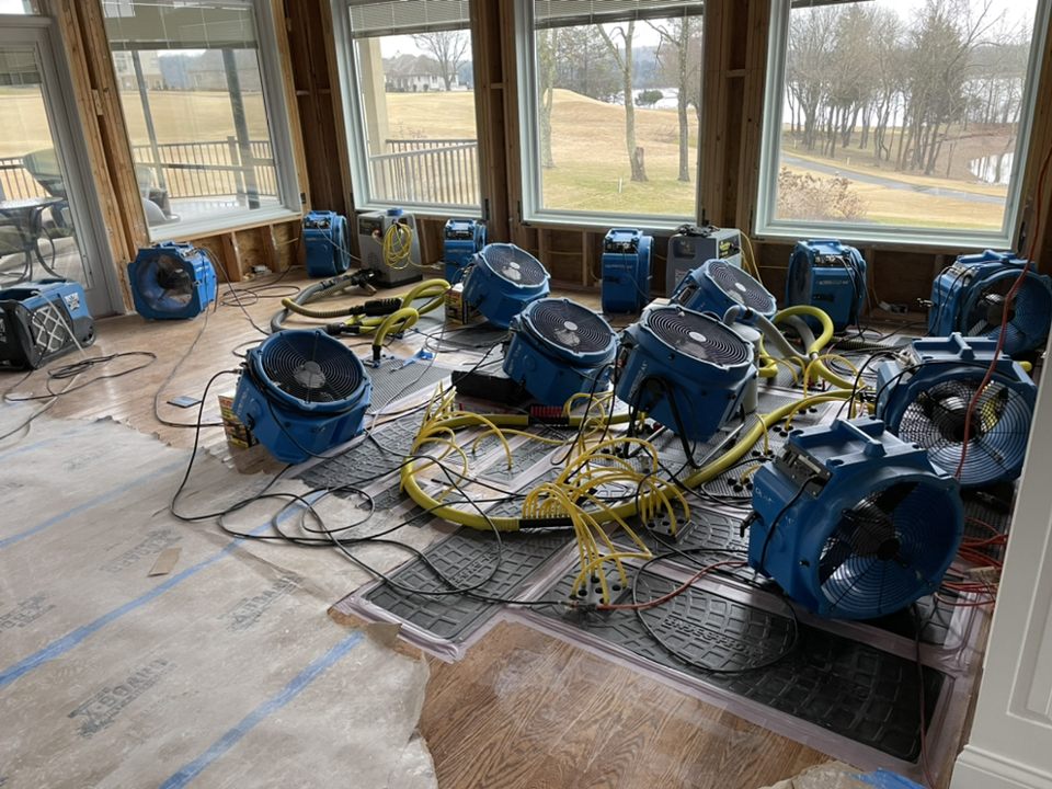Industrial air movers drying a residential home after flood damage