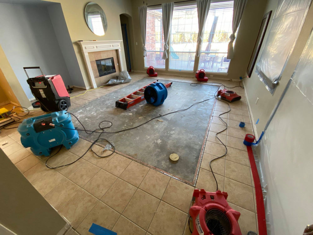 Professional drying equipment operating inside a water-damaged home