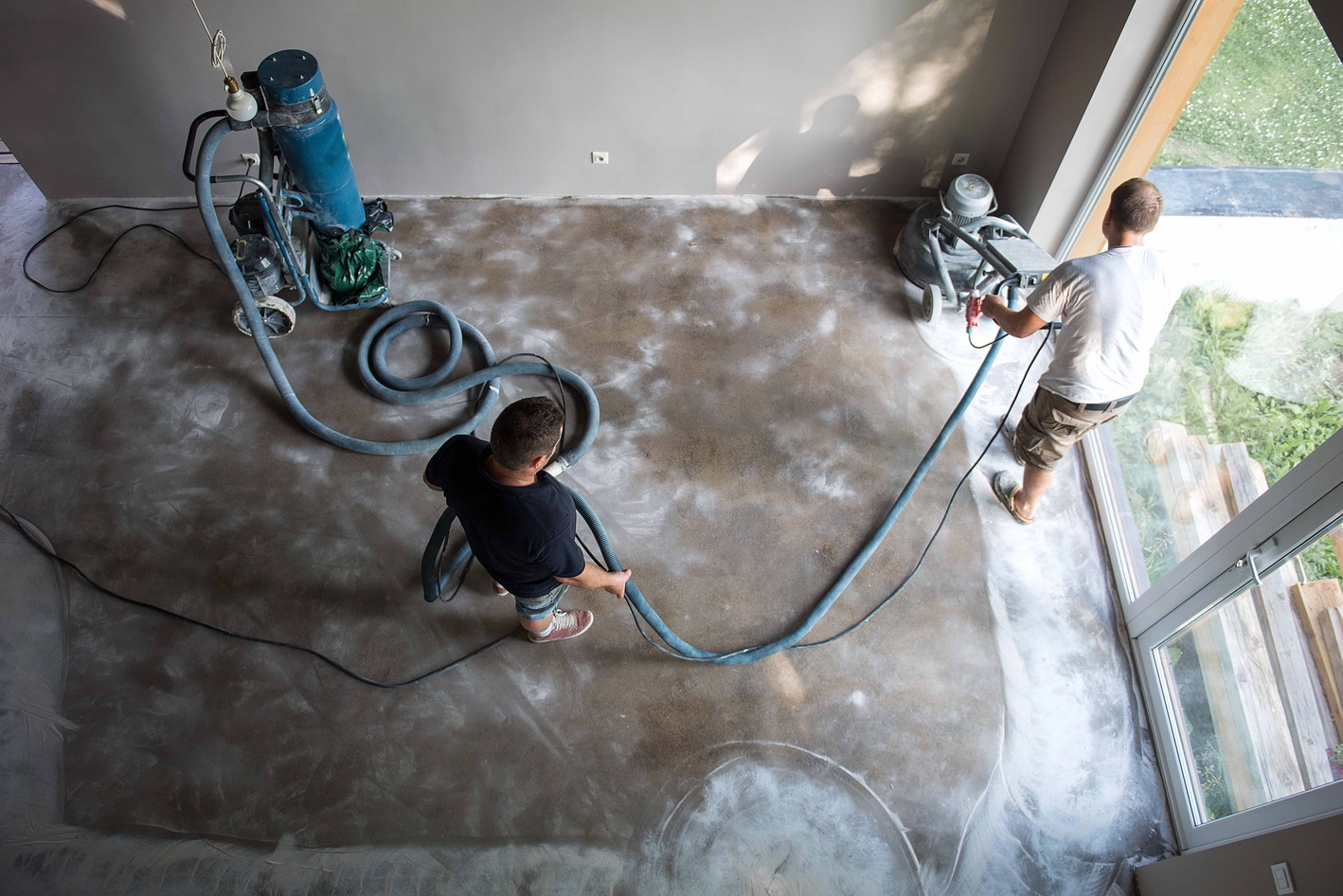 Restoration crew using professional surface-cleaning equipment inside a home